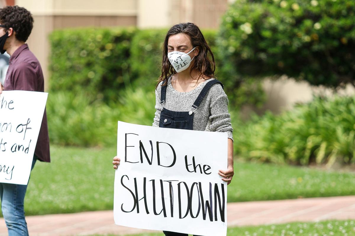 A small group of citizens protest the coronavirus shutdown in front of the San Luis Obispo County Courthouse, Sunday, April 26, 2020.