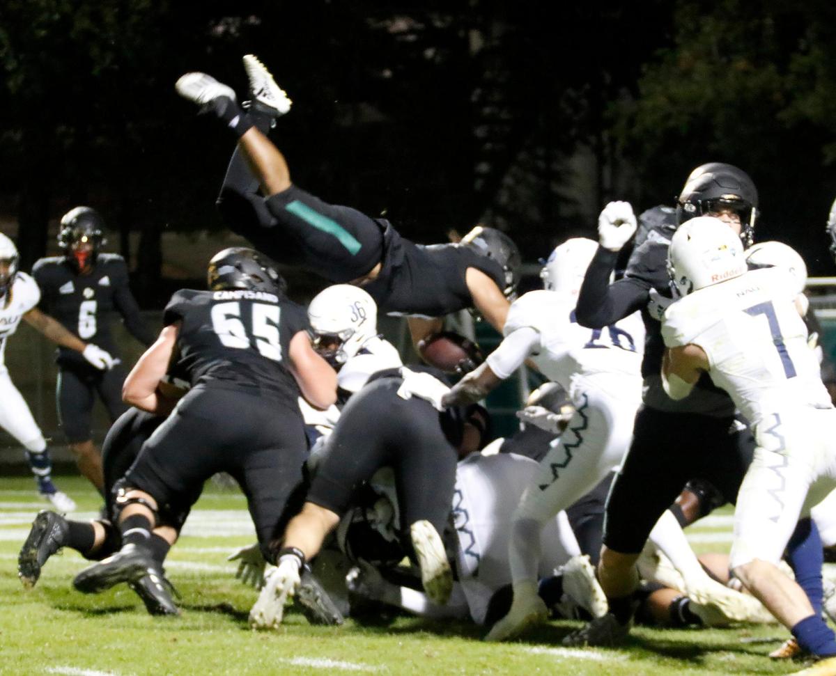 Cal Poly’s Lepi Lataimua (5) dives over the line and into the end zone for the first score of the game. In its season finale, Cal Poly fell to Northern Arizona 45-21 at Alex G. Spanos Stadium in San Luis Obispo, on Saturday, Nov. 20, 2021.