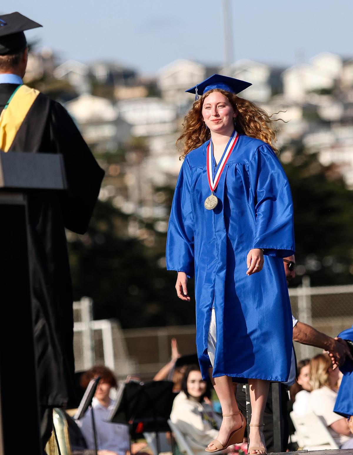 At Morro Bay High School, 180 grads were honored Thursday evening in a ceremony at the school’s football field. Salutatorian Rae Ruane walks up to receive her diploma.