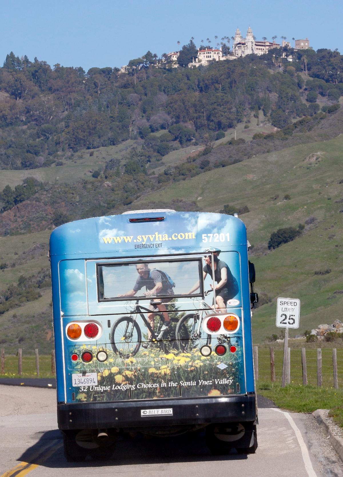 A tour bus drives the road from the Visitor Center to Hearst Castle in January 2019.