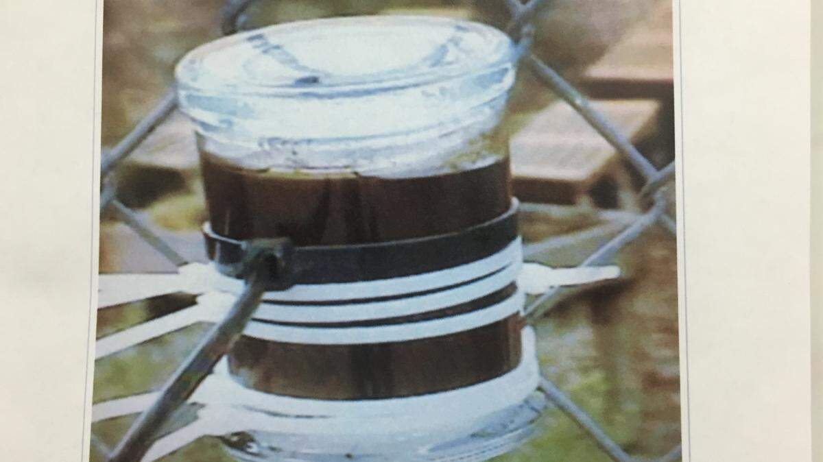 This candleholder containing sodium ferrocyanide was found zip-tied to a chain-link fence near the playground at San Gabriel Elementary School.