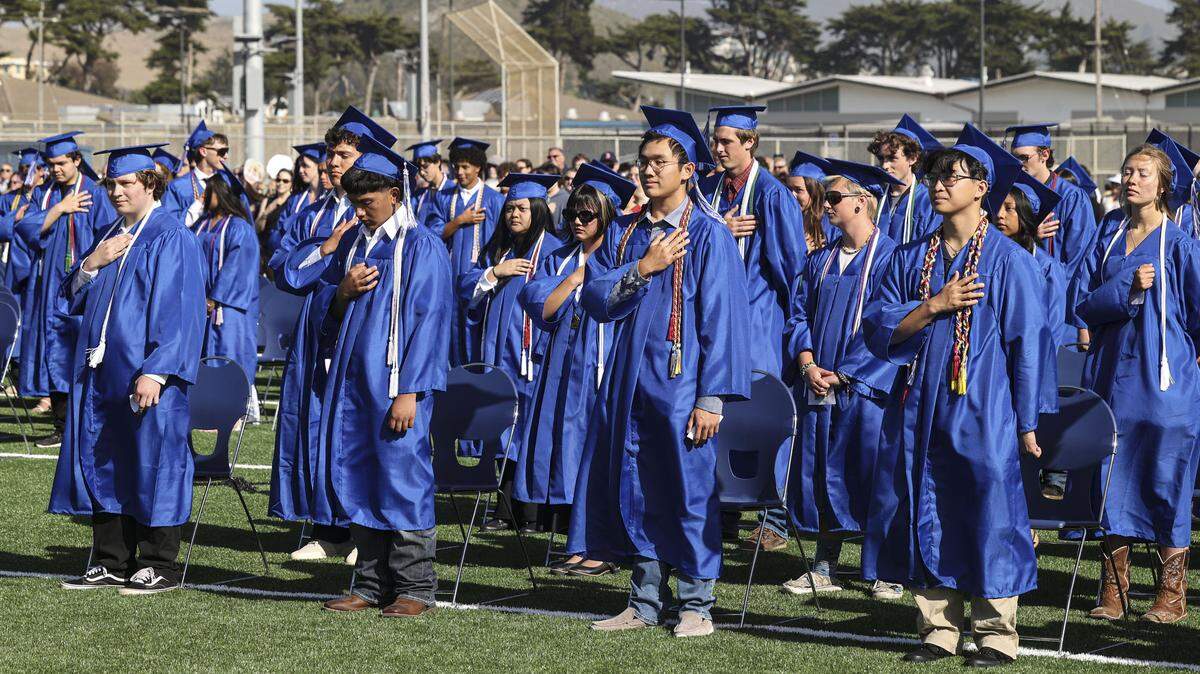 Students stand for the National Anthem sung by student Jocelyn Ocampo-Mateo. Morro Bay High School issued diplomas to 176 graduates on June 4, 2026.