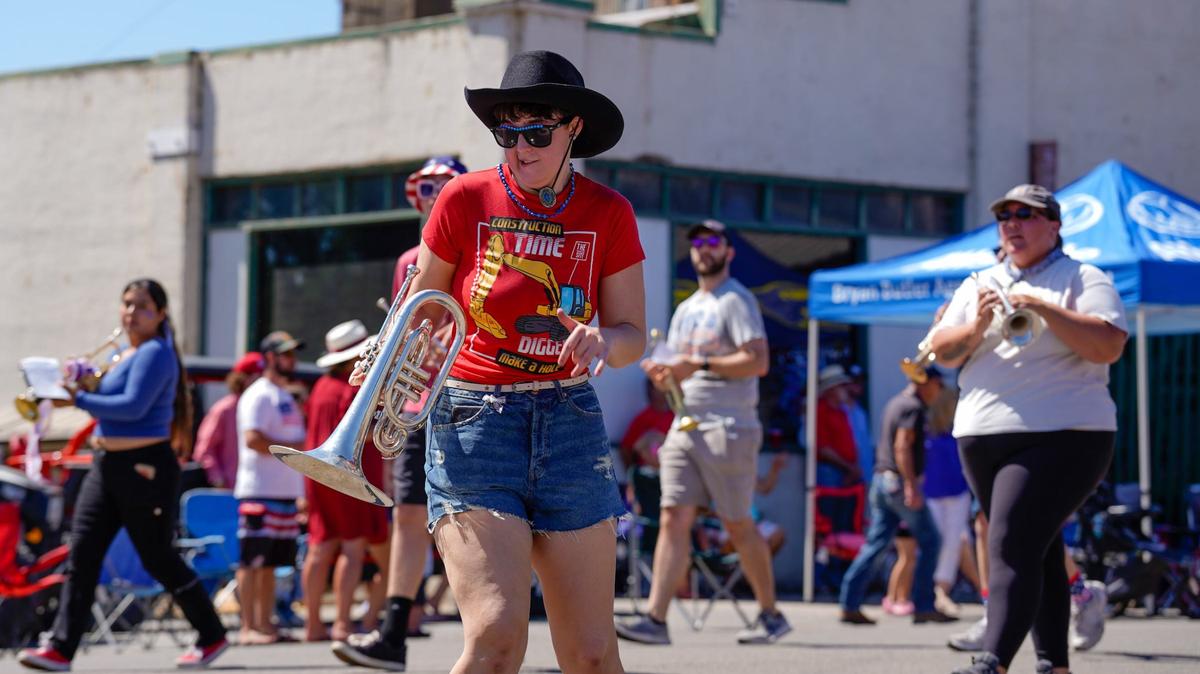 A member of the SLO County Independence Day Marching Band dances down the street in the Templeton Fourth of July Parade Thursday, July 4, 2024. The parade featured dozens of floats and acts, including classic cars, marching bands and appearances by local law enforcement and fire services.