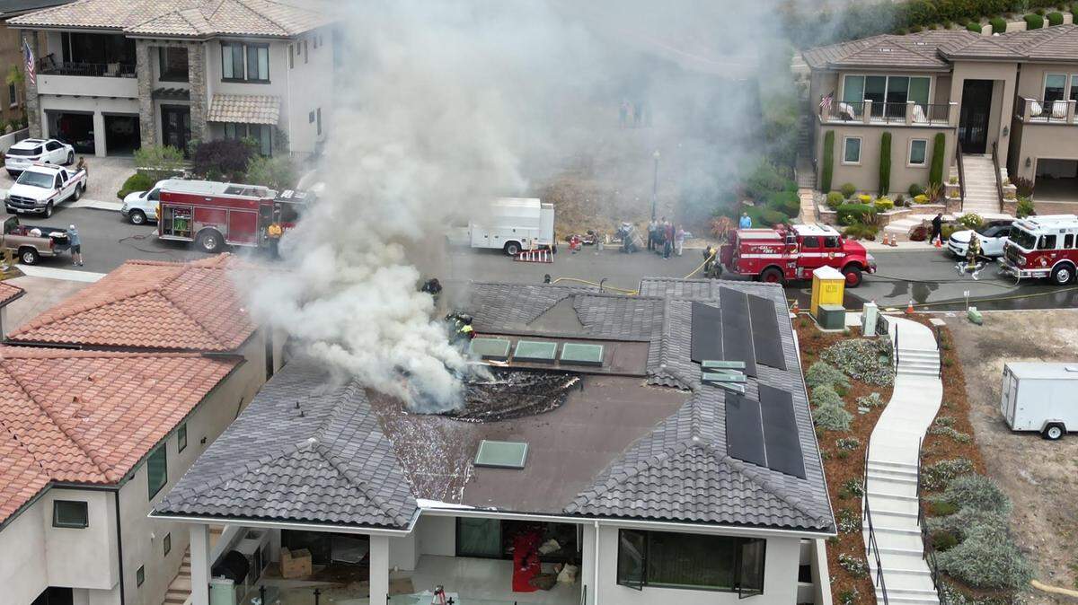 A structure fire burns the roof of a Pismo Beach home Thursday, July 18, 2024.