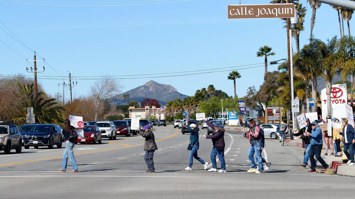 Dozens of people demonstrated outside the Tesla dealership in San Luis Obispo on Saturday, Feb. 8, 2025. They eventually walked from Calle Joaquin to Los Osos Valley Road.