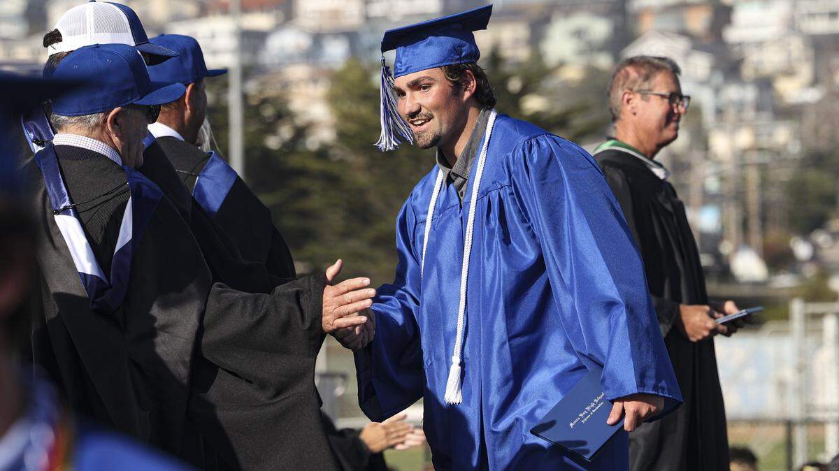 James Hatton gets handshakes from school board members. Morro Bay High School issued diplomas to 176 graduates on June 4, 2026.