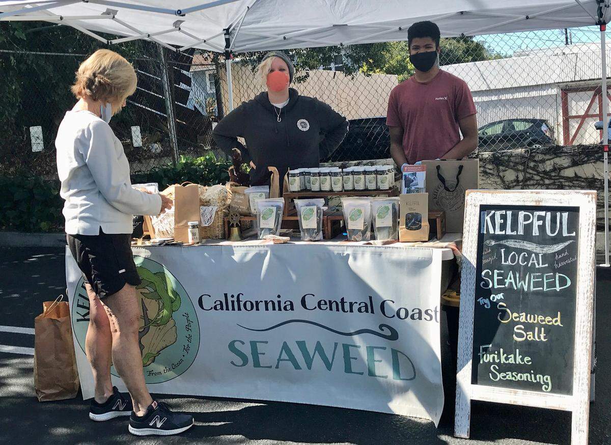 Kelpful co-founder Melissa Hanson, at center, sells seaweed products at her business booth during a FARMstead Ed pop-up market near SLO Provisions on Monterey Street in San Luis Obispo on March 27, 2021.