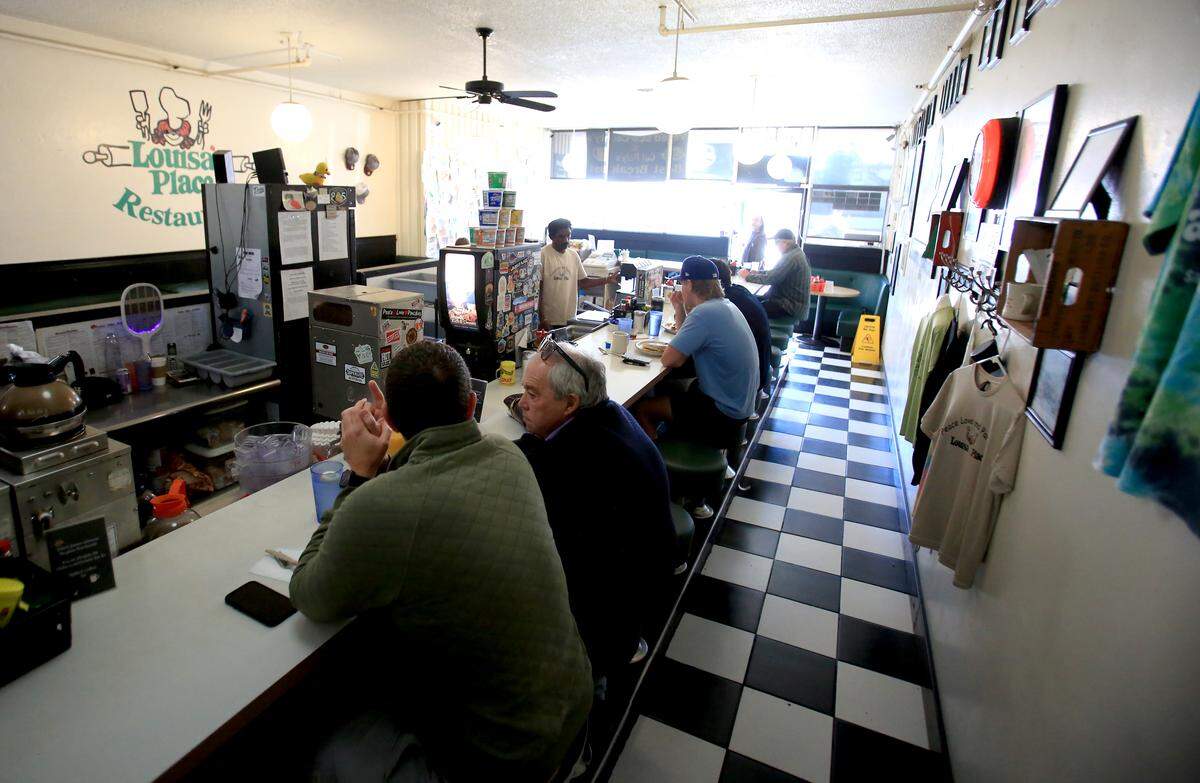 Patrons wait for their food at the Louisa’s Place counter. The restaurant has been open at 964 Higuera St. in downtown San Luis Obispo since 1958.