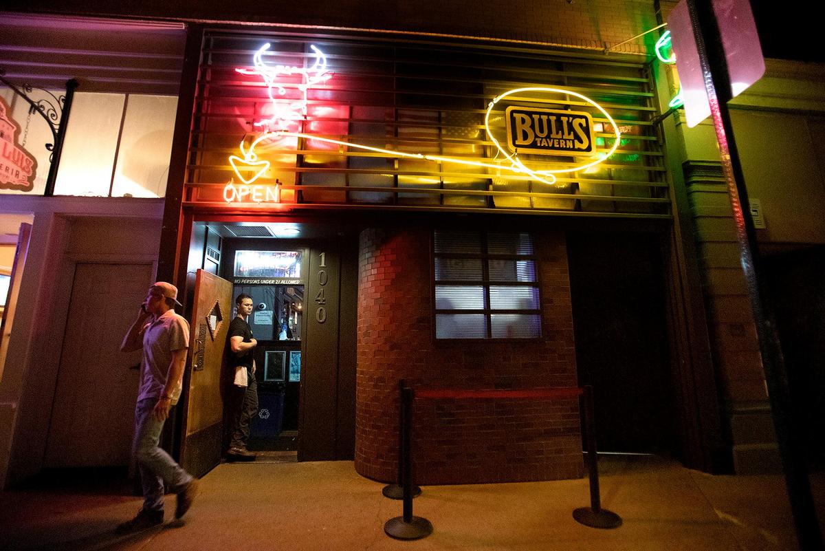 Joel Jandel mans the door at Bull’s Tavern on Friday, June 16, 2023, the night before Cal Poly’s graduation weekend. The bar has been a fixture of San Luis Obispo’s downtown scene since the 1930s.