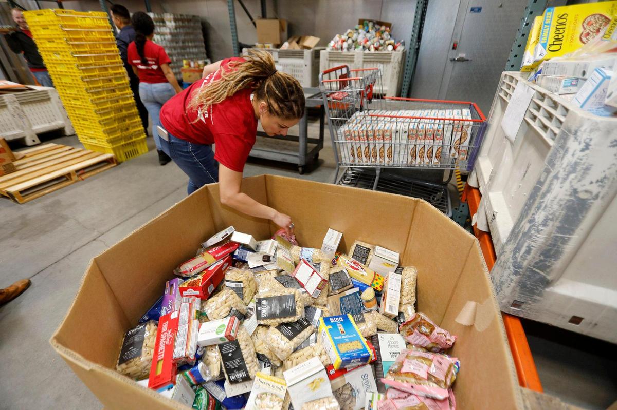 The Food Bank is in full swing for the holiday giving. Bank of America employees volunteered to package donated food in the 20,000 ft. San Luis Obispo warehouse. Linda Gonzalez, San Luis Obispo, Bank of America Financial Solutions advisor, checks a box filled with pastas and noodles Dec. 12, 2019.