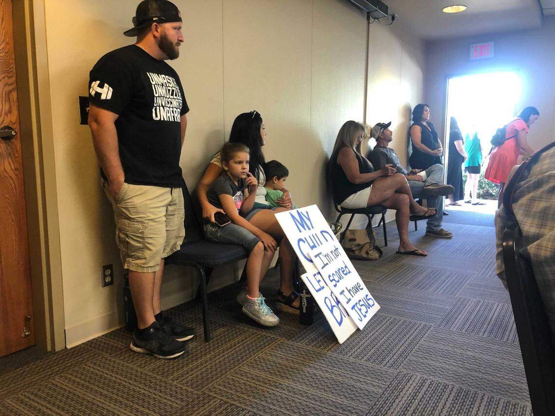 Sheriff’s Deputy Jake Loden, left, and parents from Moms for Liberty attended the Atascadero school board meeting on July 23, 2021, to ask the district not to enforce California’s mask mandate. At a meeting on Aug. 10, Loden told the board, “If you decide to segregate those kids (from those who do wear masks), there will be considerable retaliation, and, well, use your imagination of what will happen next.”