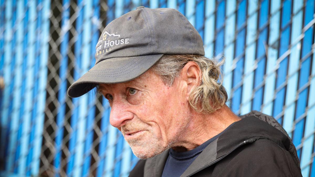 Brad Dunlap said he doesn’t have major health issues but when asked in detail he was recovering from a staph infection on his hands and a neck injury that leaves him unable to straighten his head. He was on the Bob Jones Trail near San Luis Creek, a short distance from 40 Prado Homeless Services Center Oct. 9, 2024.