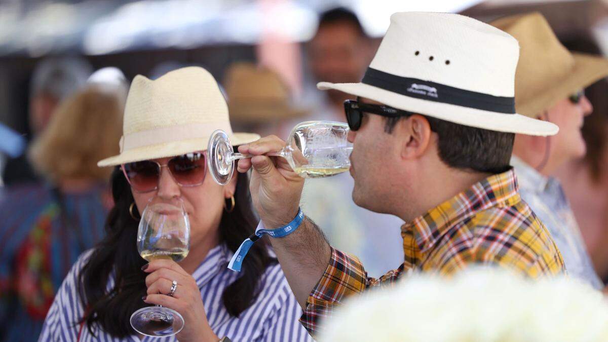 Erika and Ilario Idoni from Pasadena sample wine at the Paso Wine Fest on Saturday, May 21, 2022, at the Paso Robles Event Center. San Luis Obispo County saw $2.3 billion in total travel spending in 2023, according to a new report.