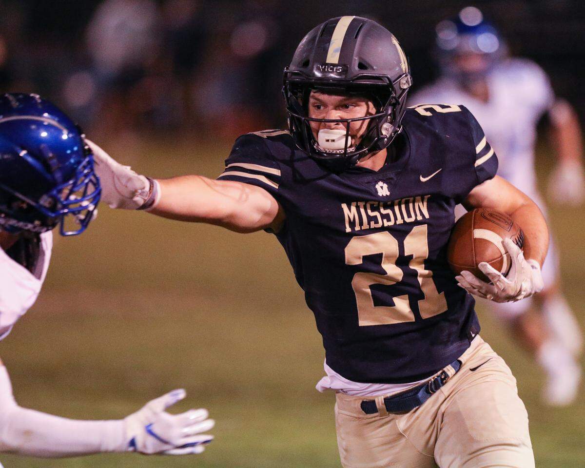 Drew Harrigan uses a straight arm to gain yardage. Mission Prep scored often and kept Morro Bay out of the end zone finishing with a 60-3 win.