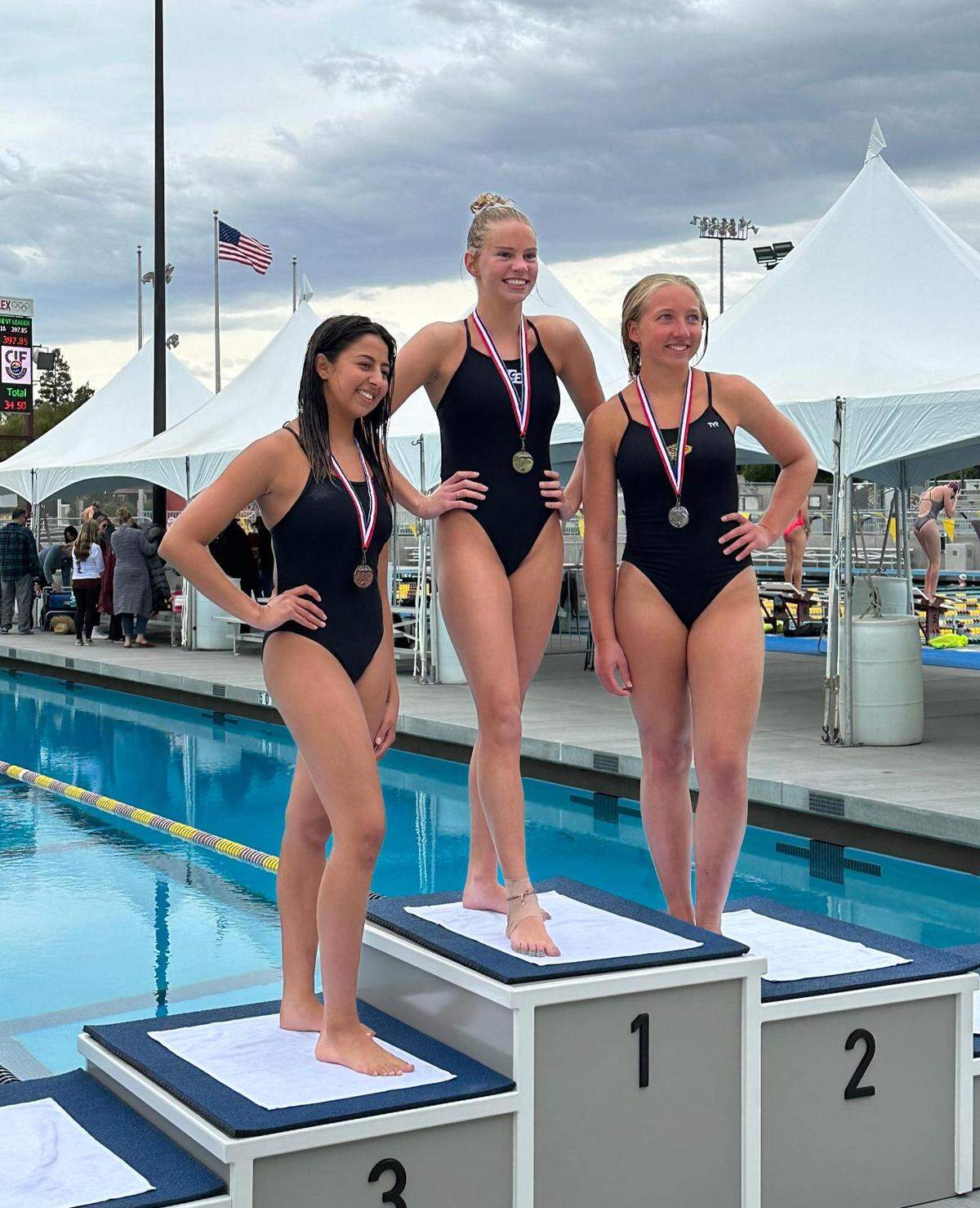 San Luis Obispo High School diver Julia Bellardo, far right, finished second at a meet earlier this year.