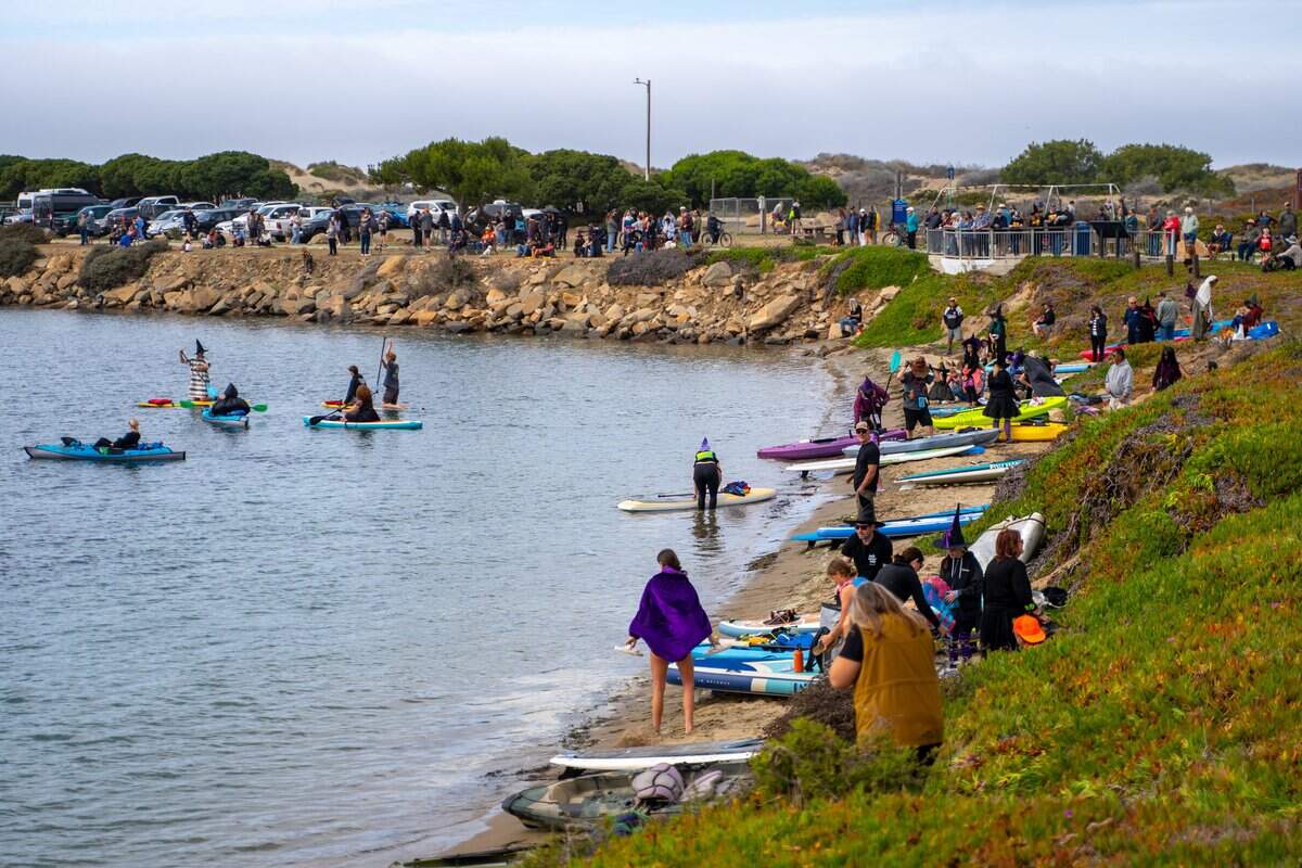Witches and other creatures of the night launch their kayaks in the water near Coleman Park at the Witches Paddle in Morro Bay on Saturday, Oct. 25, 2025. The 13th annual paddle attracted hundreds of witches and creatures of the night taking to the watter on paddleboards, kayaks and other small craft.