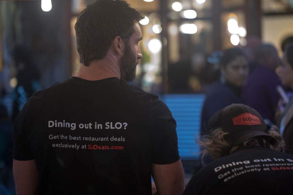 SLOeats co-founder Jonathan Allen sports a SLOeats T-shirt while promoting the restaurant deals app in downtown San Luis Obispo.