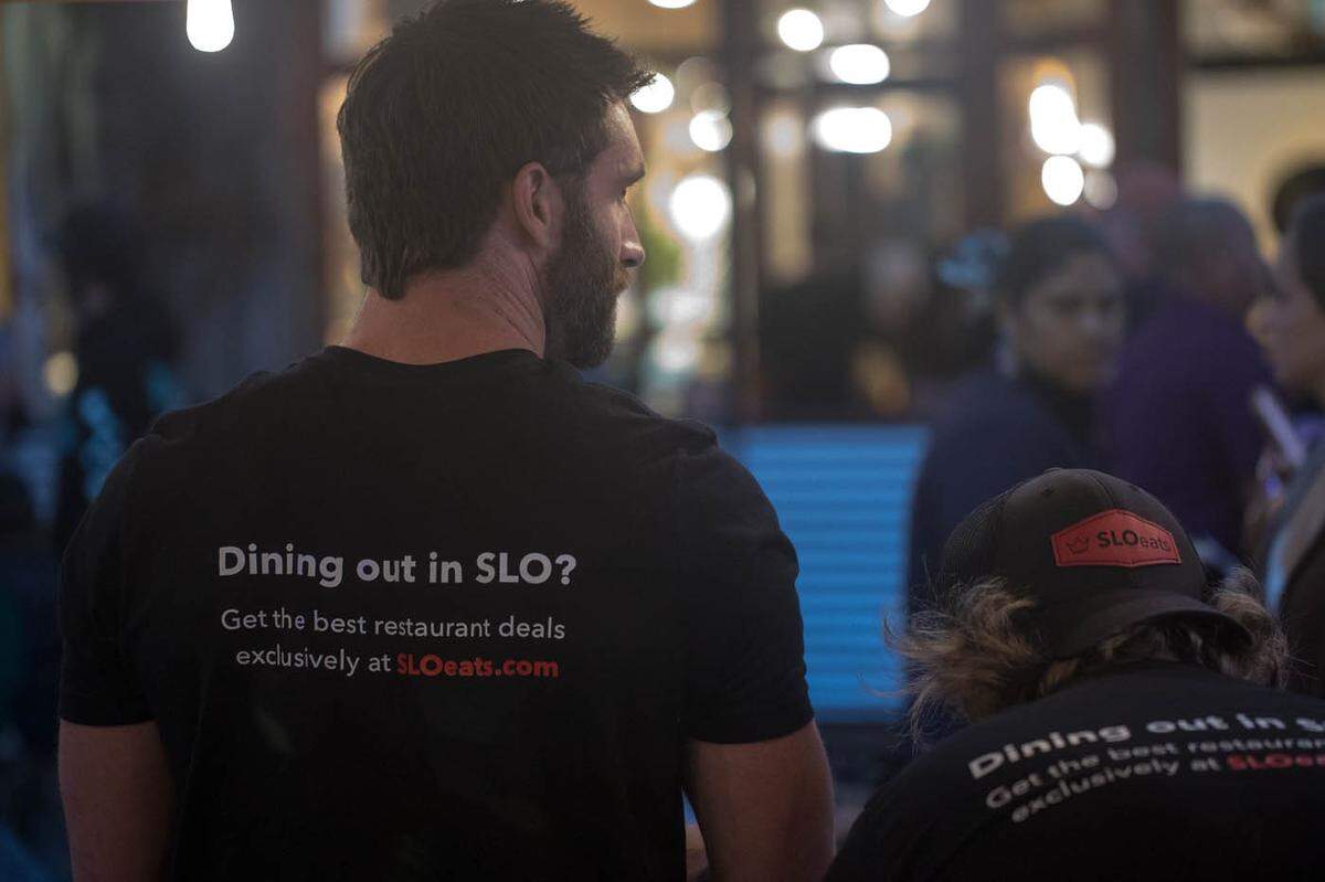 SLOeats co-founder Jonathan Allen sports a SLOeats T-shirt while promoting the restaurant deals app in downtown San Luis Obispo.