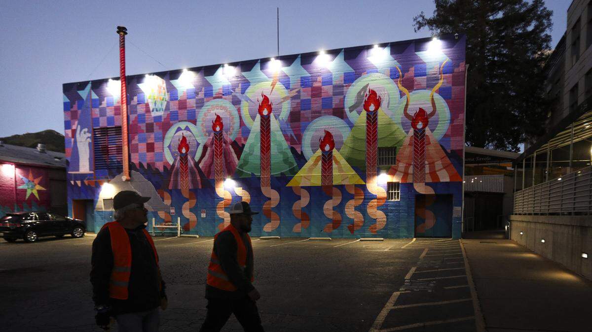 Henry Titzler, left and Jesus Cortes walk by the back of the Fremont Theater. Volunteers making the Point-In-Time Count of unhoused were out before dawn on Jan. 27, 2026.