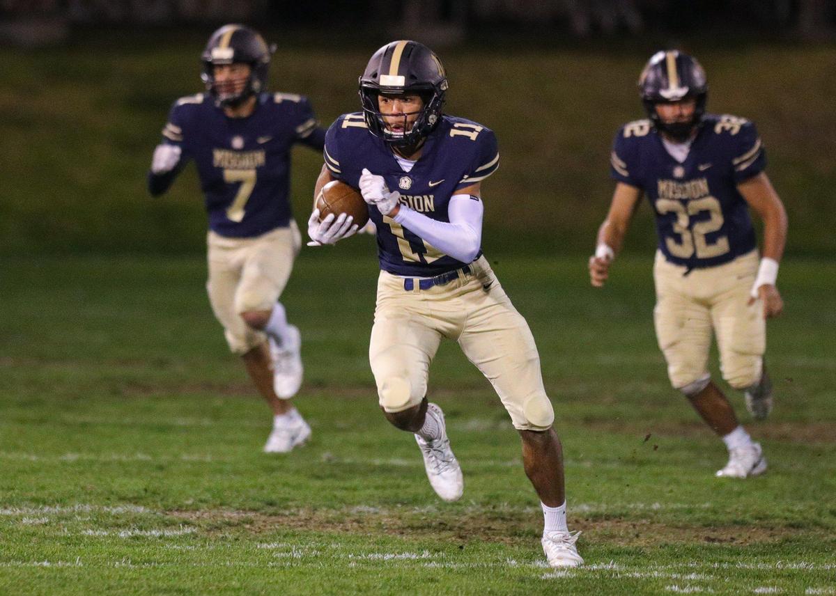 Jamar Howard runs back a kickoff for over 40 yards flanked by 7, George Kardashian and 32 Isaac Townsend. Mission Prep fell to Kennedy 27-14 (from Delano) in a football playoff Nov. 18, 2022.