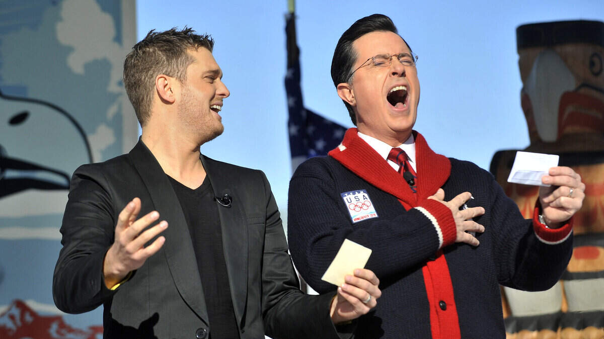 Singer Michael Buble, left, and comedian Stephen Colbert sing a combined version of the American and Canadian national anthems. (Ian Lindsay / Canwest News Service / MCT)