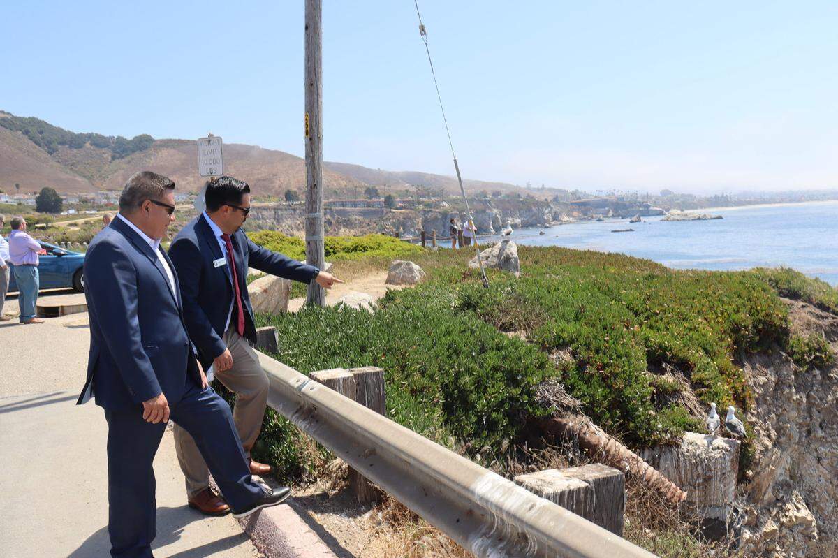 Congressman Salud Carbajal, left, visited the eroding bluffs near Dinosaur Caves Park with Pismo Beach City Manager Jorge Garcia, right, on Thursday, Aug. 8, 2024. The Bipartisan Infrastructure Law will provide $200,000 in funding to prevent ocean bluff erosion at Dinosaur Caves Park in Pismo Beach. The $3.1 million project with replace all of the storm drain infrastructure and add a secure wall to protect the street and ocean bedrock.