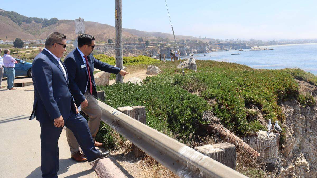 Congressman Salud Carbajal, left, visited the eroding bluffs near Dinosaur Caves Park with Pismo Beach City Manager Jorge Garcia, right, on Thursday, Aug. 8, 2024. The Bipartisan Infrastructure Law will provide $200,000 in funding to prevent ocean bluff erosion at Dinosaur Caves Park in Pismo Beach. The $3.1 million project with replace all of the storm drain infrastructure and add a secure wall to protect the street and ocean bedrock.