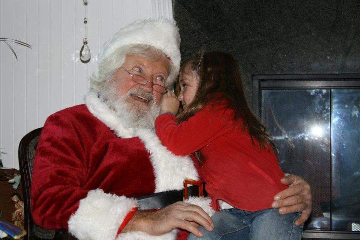Tom Tierney of Cambria has portrayed Santa Claus so many times through the decades that his family nickname is “Grandpa HoHo.” Here, he’s shown with his granddaughter Hannah Scheller in 2008.