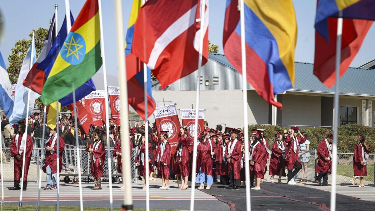 Students line up under a display of international flags. Nipomo High School issued diplomas to 198 graduates on June 5, 2026.