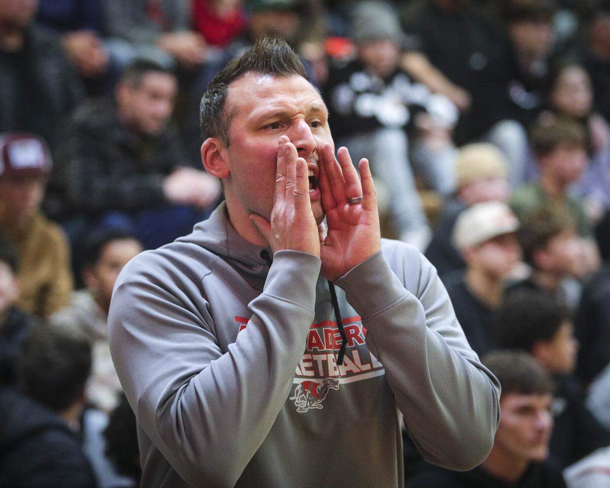 Greyhounds head coach Augie Johnston shouts instructions to players. Atascadero beat Sanger 82-41 in a baskeball playoff Feb. 17, 2026.