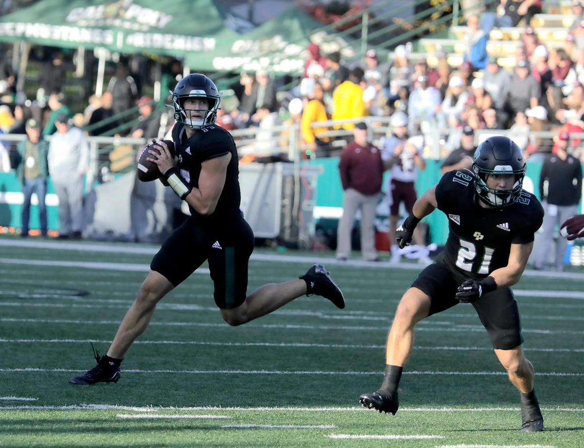 Cal Poly quarter back Richie Watts looks for a receiver instead of a handing the ball to Troy Fletcher. Cal Poly lost to Montana 42-7 in a college football game at Mustang Memorial Stadium on Nov. 2, 2024.