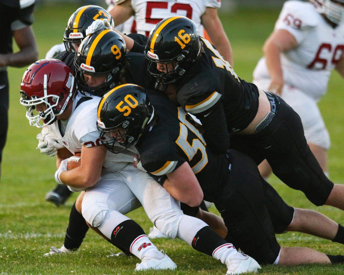 Leo Kemp is tackled by #53 Luca Cuccaro, #50 Rory Devaney, #9 Gavin Righetti and #16 Link Danninger. San Luis Obispo hosted Paso Robles for the second game of the coronavirus shortened, late start to football season.