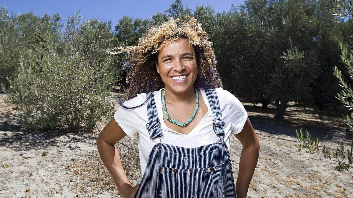 Julie White-Chaples stands among her olive trees in Shandon.