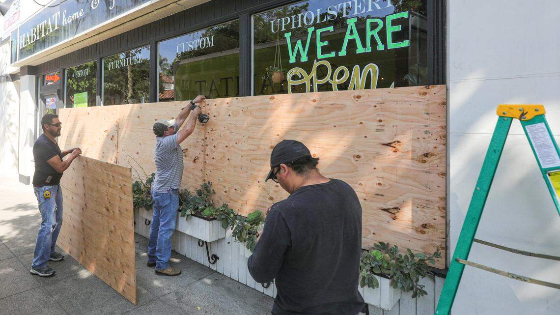 Workers board up the windows at Habitat on Marsh Street on Wednesday June 3, 2020, as Black Lives Matter marches continued in San Luis Obispo.