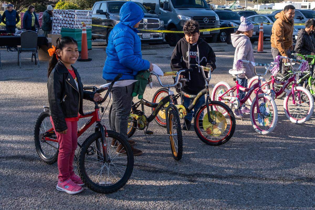 Bernadita Flore, 9, poses with her new bike she got during the San Luis Obispo County Sheriff’s Office bicycle giveaway on Dec. 13, 2022 — Flore’s birthday.
