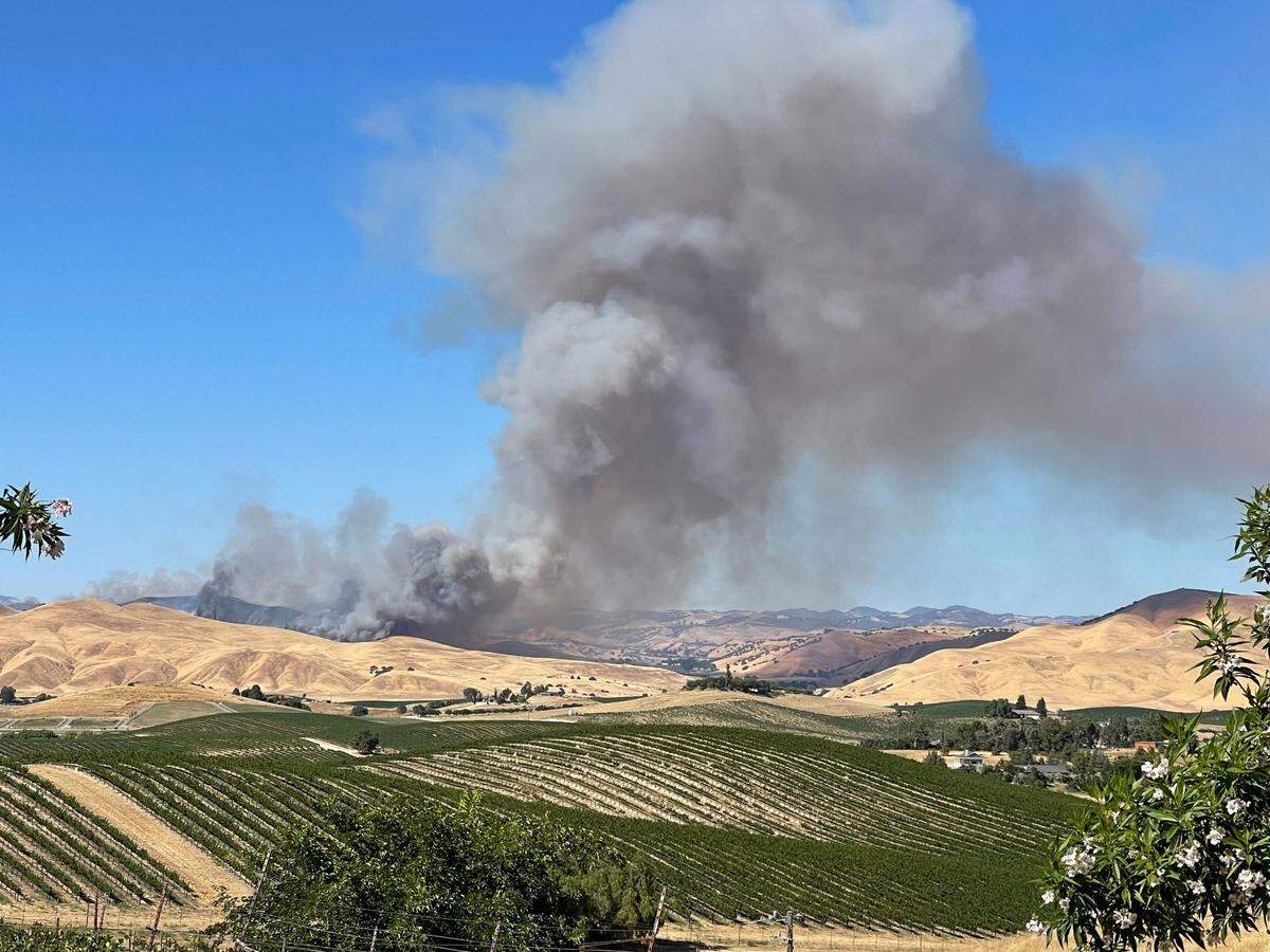 Smoke rises from the Vineyard Fire burning in San Miguel on Sunday, July 9, 2023.