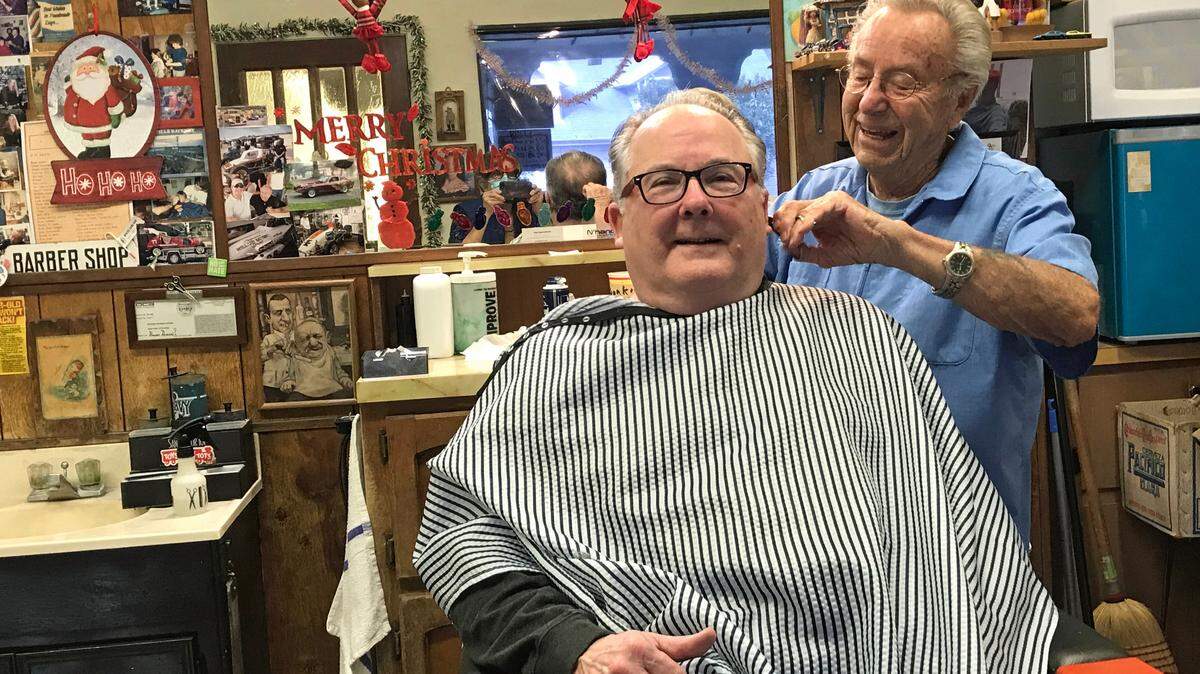 Barber Corky Miles, 94 of Cambria, finishes a haircut for one of his many longtime customers and friends, Tom Middleton. Miles opened his first Cambria barber shop in 1972, and has been cutting hair there ever since.