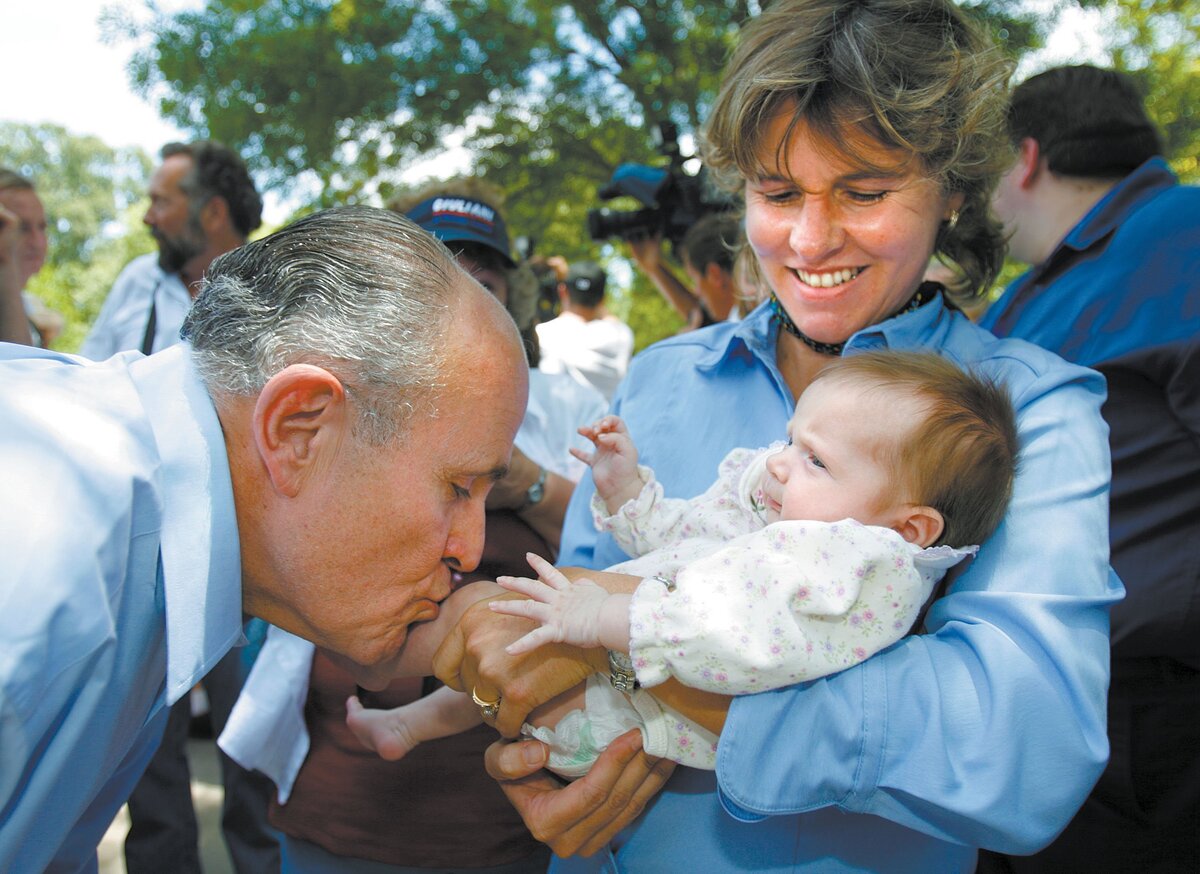 Rudy Giuliani kisses the leg of 7-month-old Dana Petker as her mother Kathy Petker, of Arroyo Grande, looks on during the candidate's visit to Santa Margarita on June 11, 2007. Petker said she read Giuliani's book out loud to the baby.
