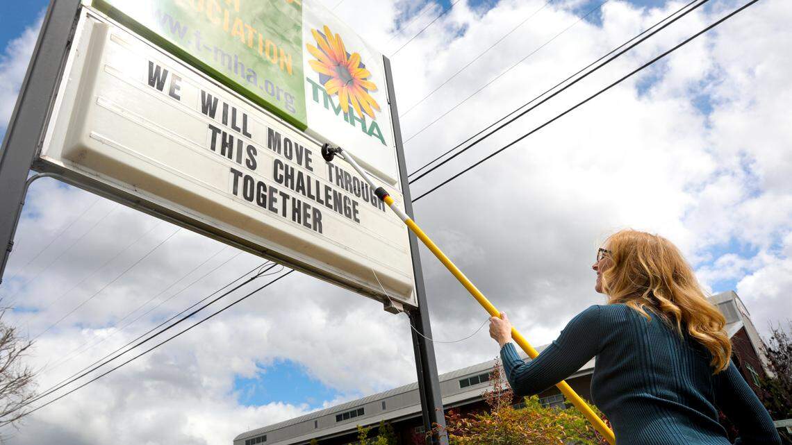 Caity McCardell, community resource coordinator with Transitions Mental Health, changes the message sign to a note of encouragement as shelter in home takes place due to coronavirus. The office is in San Luis Obispo and the sign faces Santa Barbara Avenue.