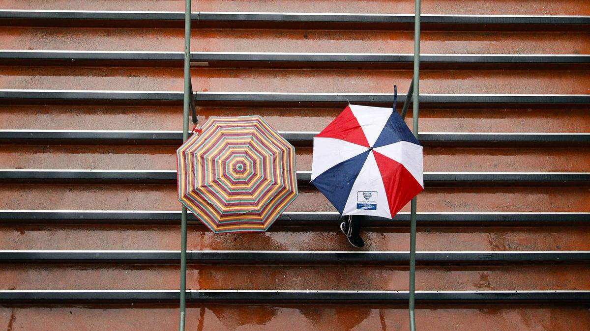 A pair of moviegoers heads to the Downtown Centre Cinemas for a show under the cover of umbrellas Tuesday, April 7, 2015.