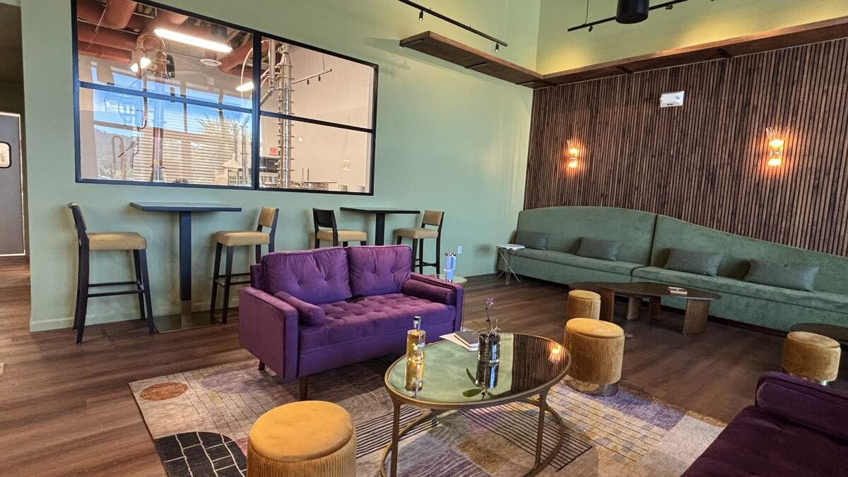 The interior of Central Coast Distillery in Atascadero is colorful — with purple and green couches and tables of two, seen here on July 2, 2026.