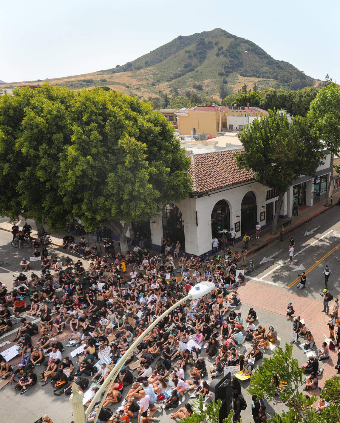 Protesters sit and listen to speeches in the intersection of Chorro and Marsh Street during a protest in San Luis Obispo on June 3, 2020.
