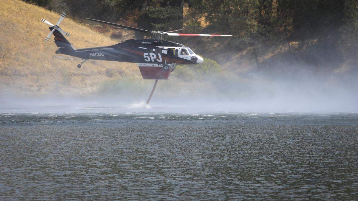 Helicopters dipped water out of Santa Margarita Lake while fighting the Gifford Fire on Aug. 11, 2025.