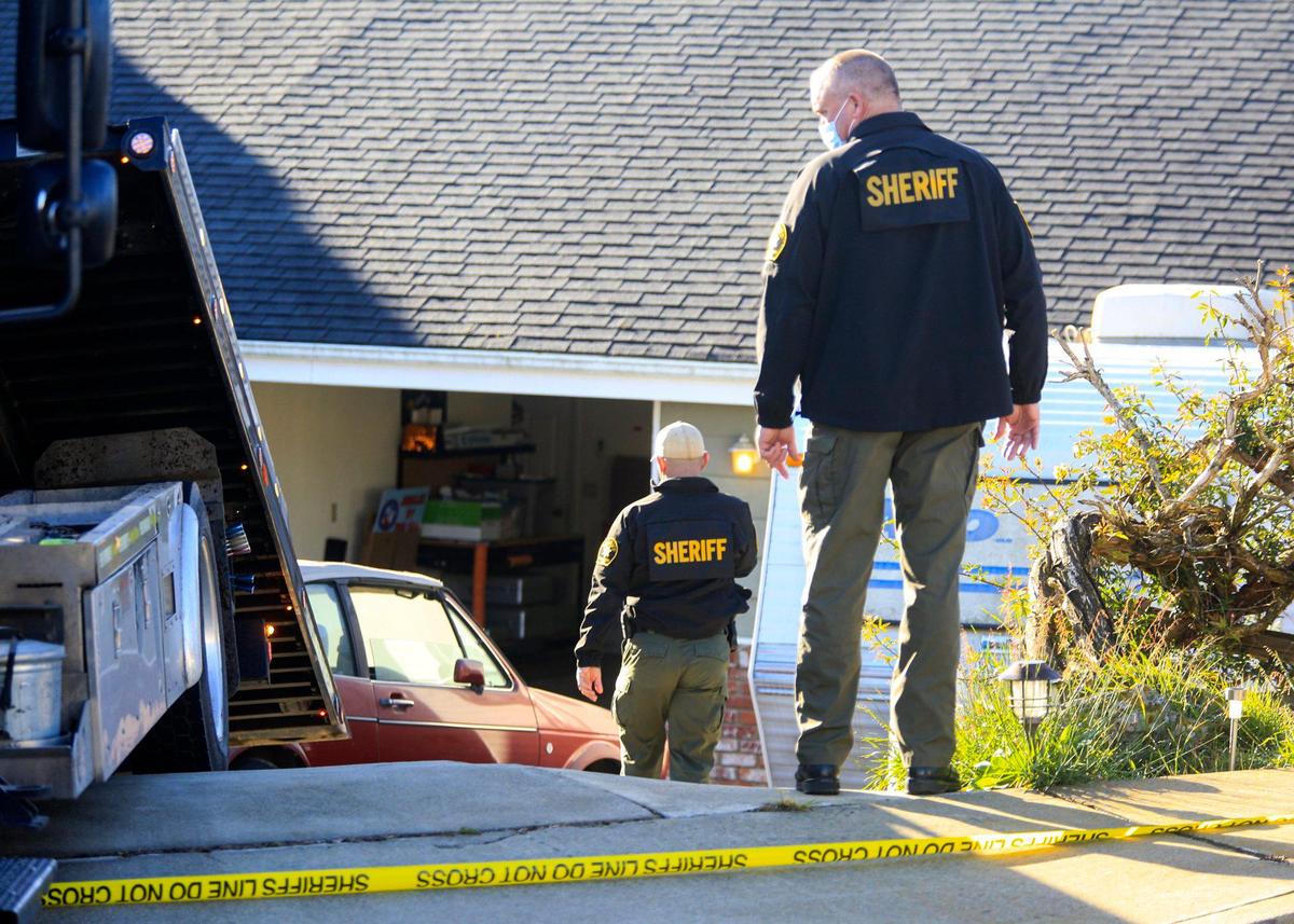 Deputies prepare to have a car towed for evidence under a warrant on March 15, 2021. 