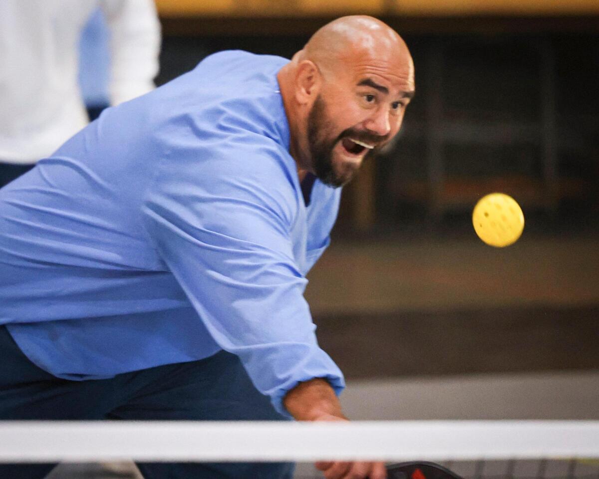 California Men’s Colony inmate Virgil Zwicker reaches to return a pickleball. A film crew was recording how the sport can break down barriers and provide positive interactions between inmates and staff on Nov. 12, 2024.