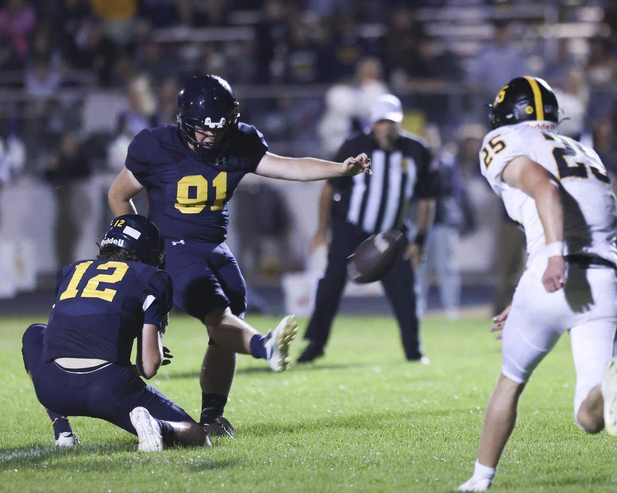 Dustin Reed kicks the point after held by Jacob Kreowski. Arroyo Grande beat San Luis Obispo 42-28 on Sept. 5, 2025. Arroyo Grande beat Bakersfield in the CIF title game on Nov. 28, 2025.