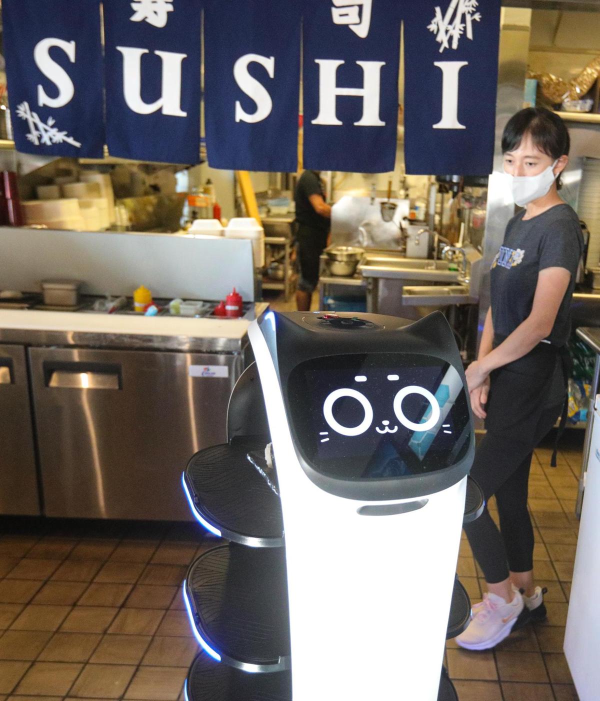 Manager’s Crystal Cui programs the BellaBot robot server to deliver a meal at Yanagi Sushi in San Luis Obispo on Aug. 29, 2022.