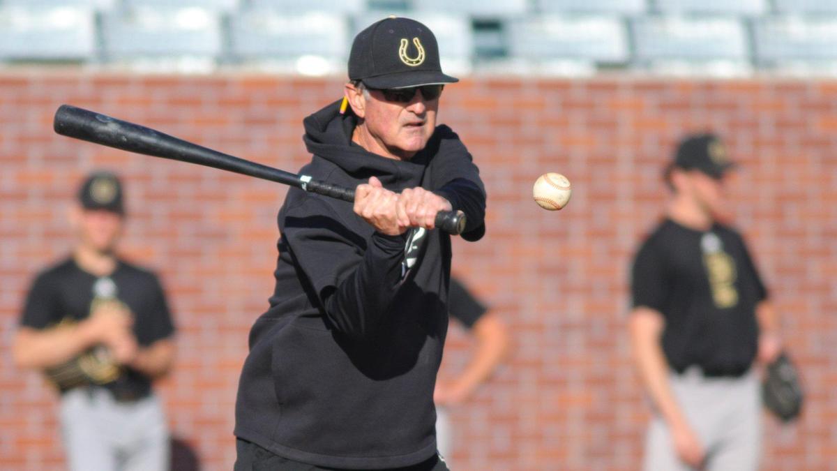 Head coach Larry Lee hits infield grounders as the Cal Poly baseball team practices on Feb. 14, 2023, before opening the baseball season against Missouri State.