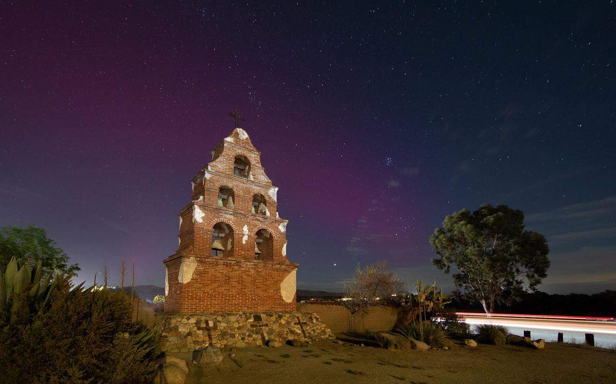 The northern lights illuminate the skies above the San Miguel Mission on October 10, 2024.