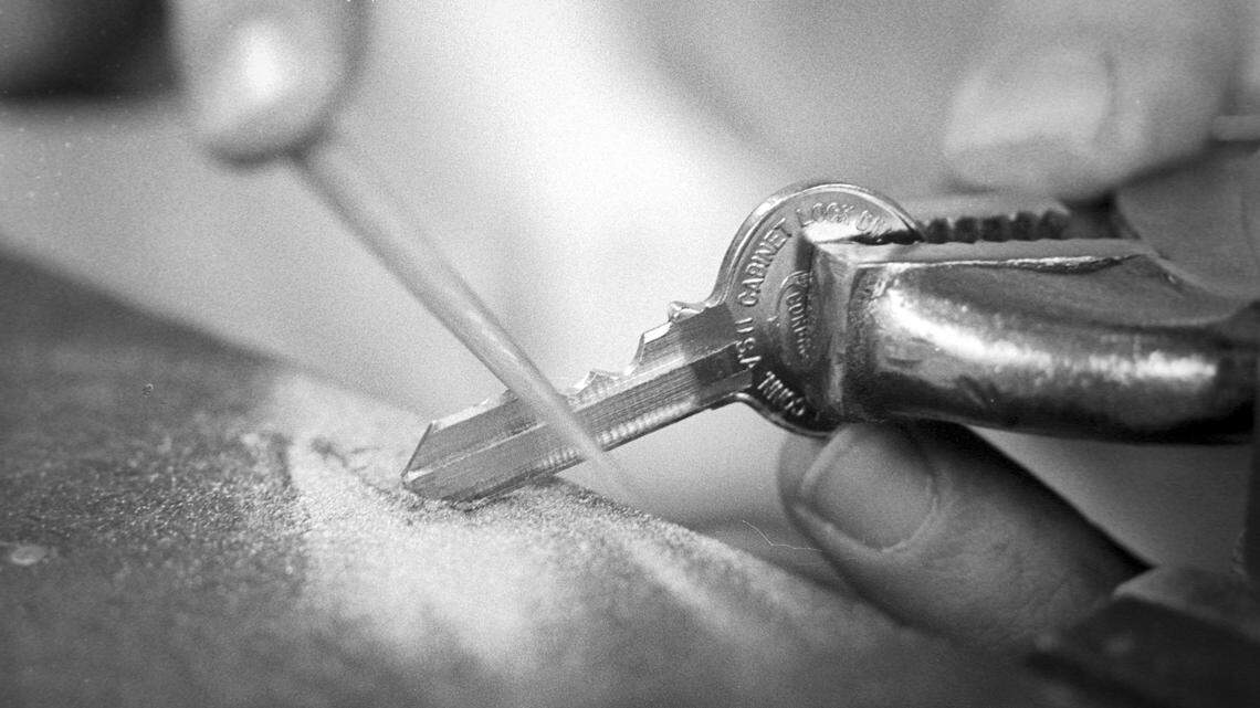 Mike Walsh hand files new key for lock with missing serial number at Cal Poly on Nov. 17, 1978.